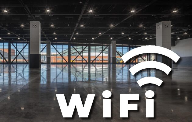 Empty modern indoor space with large windows and WiFi symbol.