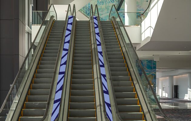 Three escalators in a bright, modern indoor space.