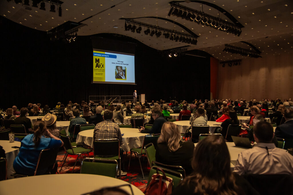 Audience attentively listening to a speaker at a conference or seminar.