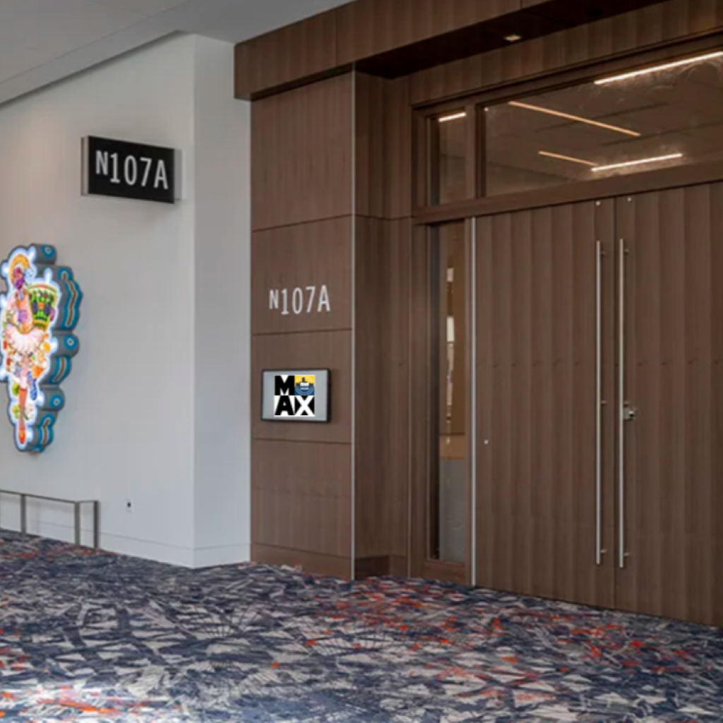 Elevator doors at a hotel hallway with room numbers displayed.